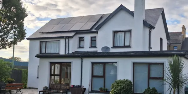 Solar panels on the rear roof of a white family home